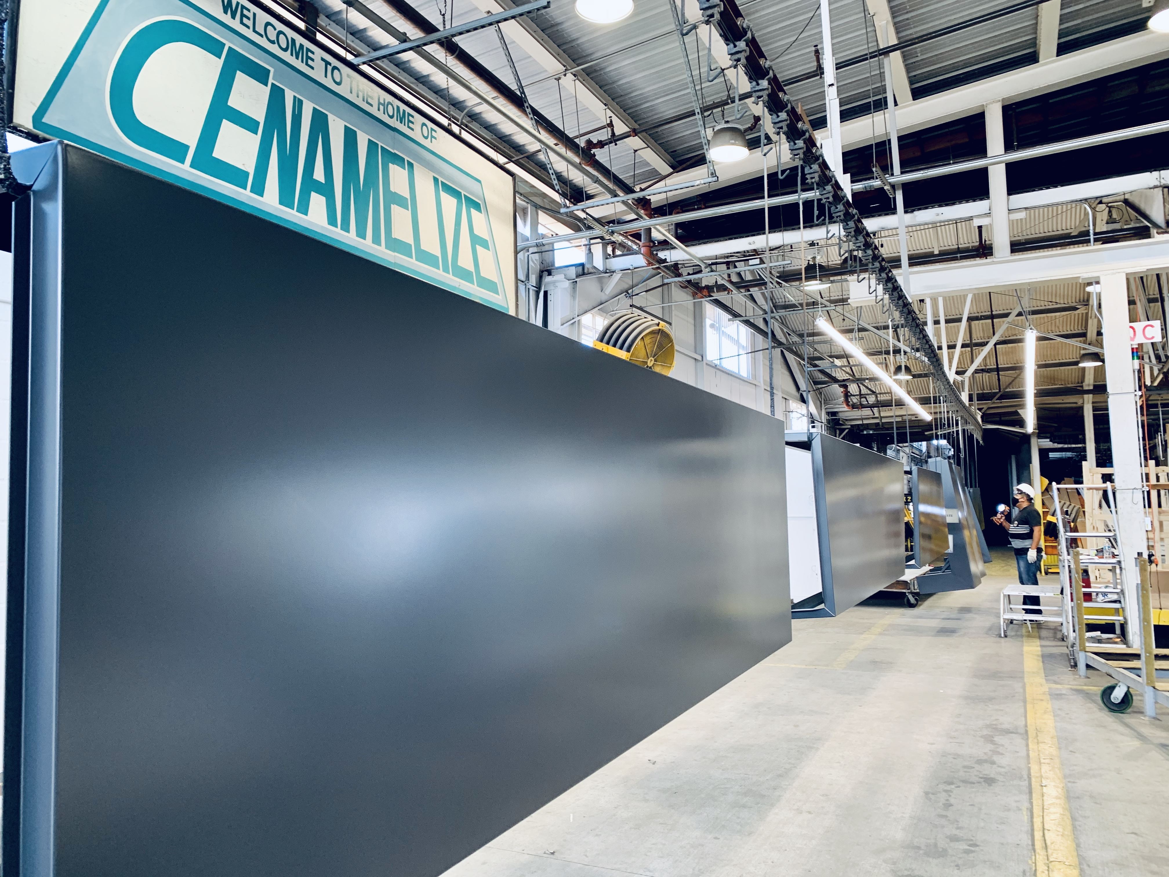The interior of the Certified Enameling, Inc. facility with a sign that says, "Welcome to the home of Cenamelize"